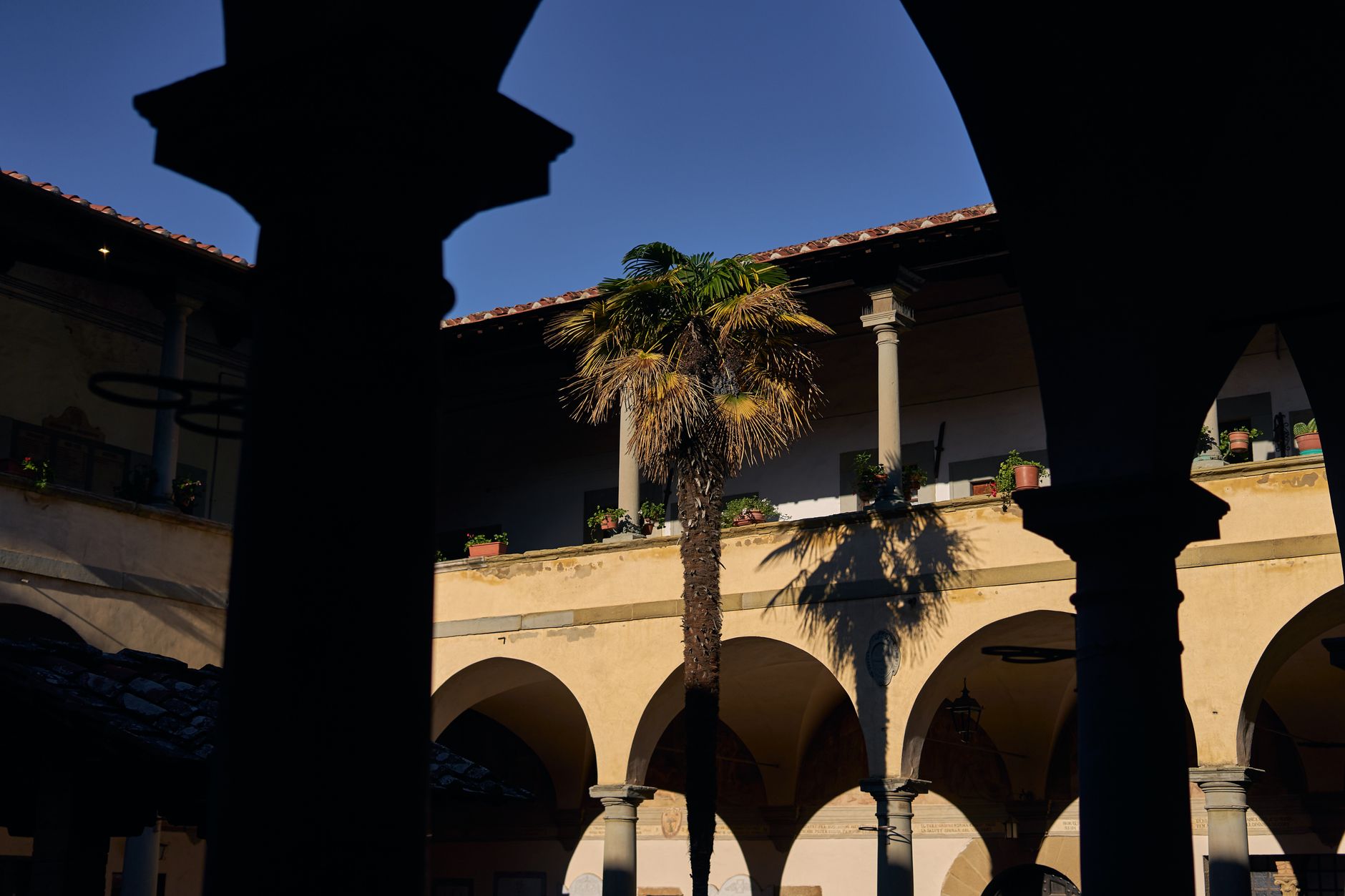 Sunlight illuminating stone courtyard in historic villa